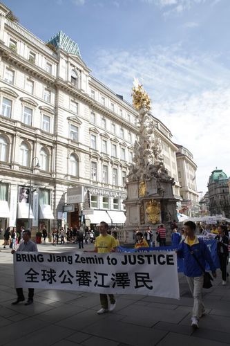 Falun Gong-Praktizierende tragen Transparente über die Strafanzeigen gegen Jiang Zemin. 